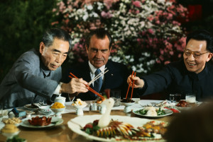 February 27,1972, Shanghai, China --- President Nixon holds his chopsticks in the ready position as Premier Chou En-lai (left) and Shanghai Communist Party leader Chang Chun-chiao reach in front of him for some tidbits at the beginning of the farewell banquet here. --- Image by © Bettmann/CORBIS